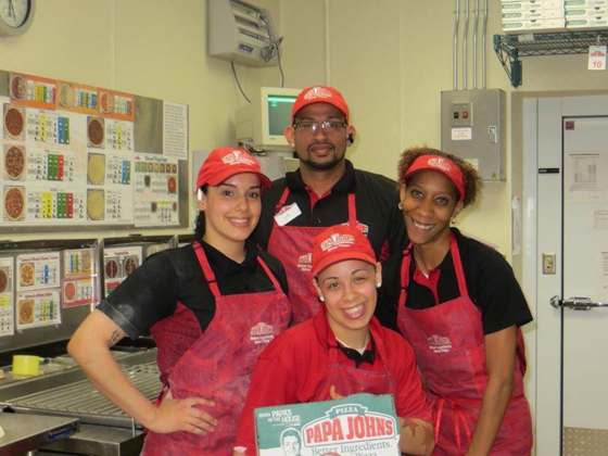 Shahani food service team in red Papa Johns uniforms