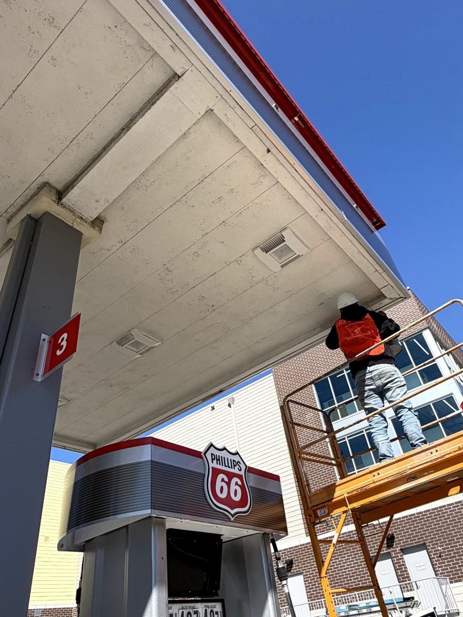 Shahani technician working at a Phillips 66 canopy